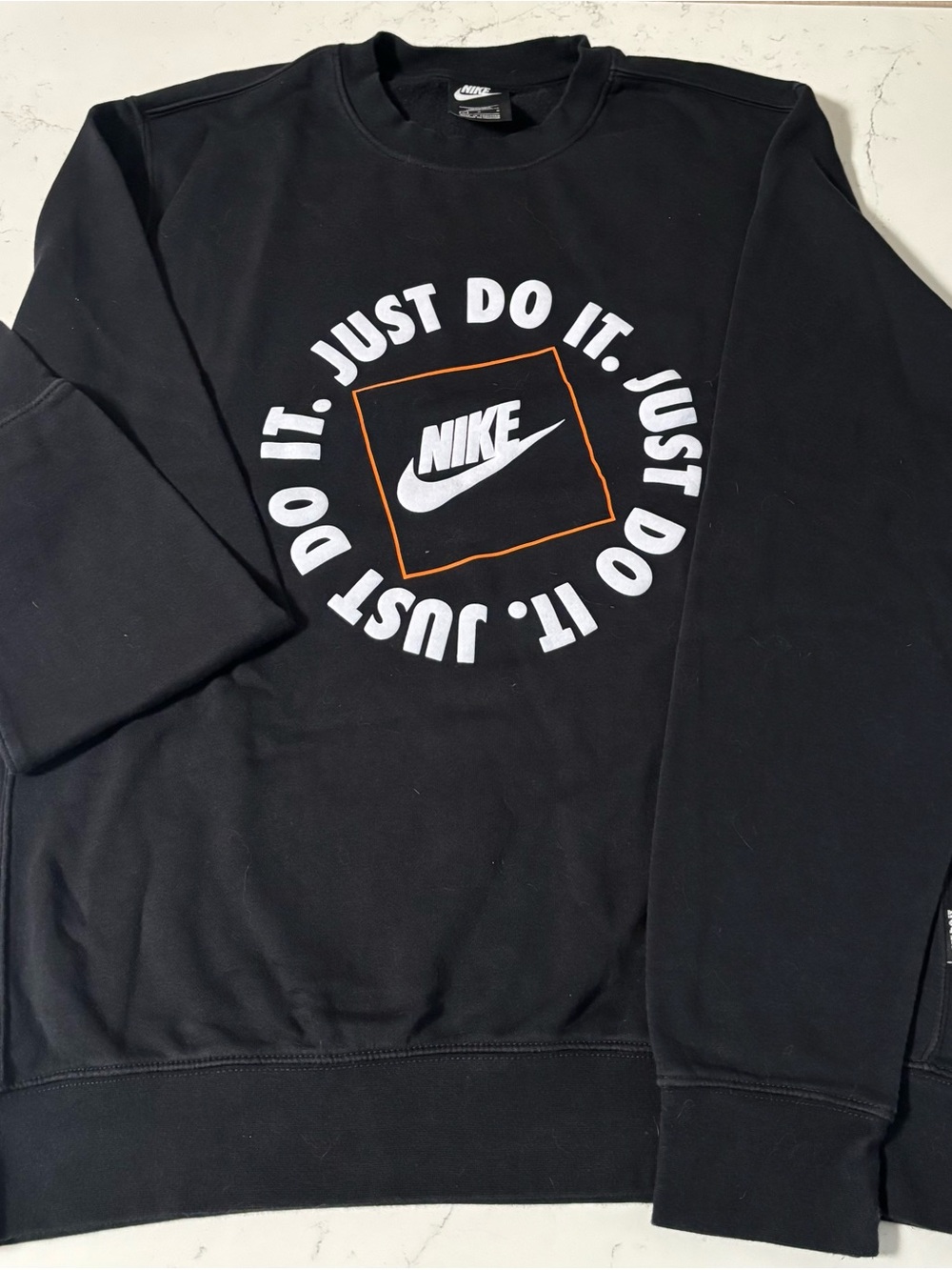 Nike Black Crewneck Sweatshirt with White 'Just Do It' Logo and Orange Accent